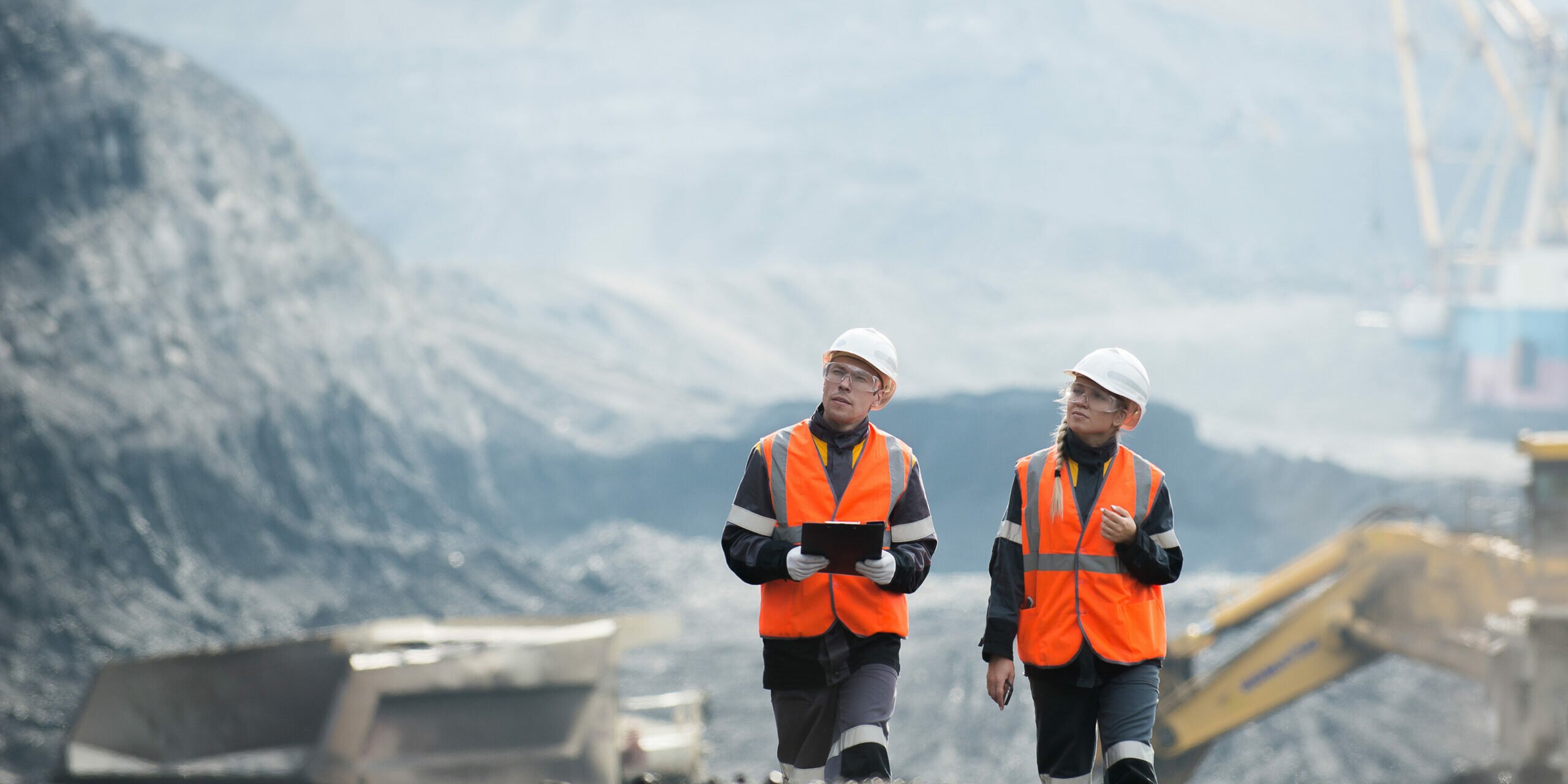 Workers with coal at open pit Two speacialists examining coal at an open pit